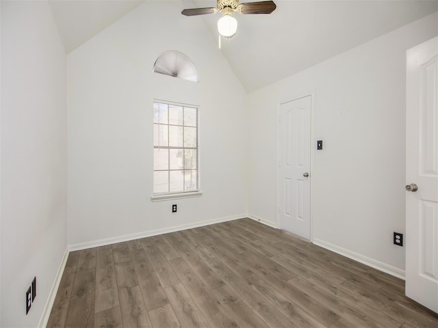 unfurnished room featuring high vaulted ceiling, baseboards, a ceiling fan, and wood finished floors