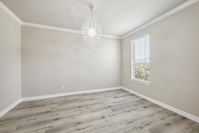 empty room with light wood finished floors, a notable chandelier, crown molding, and baseboards