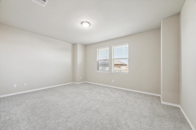 unfurnished room featuring visible vents, baseboards, and carpet floors