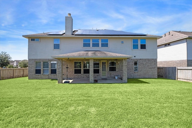 rear view of property featuring a lawn, a patio, and a fenced backyard