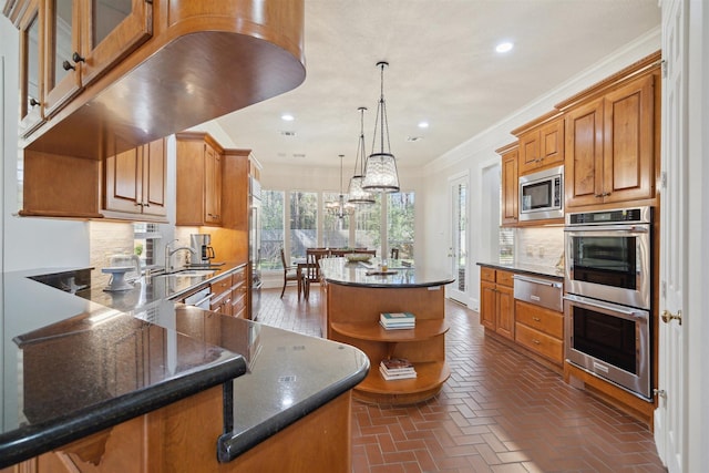 kitchen featuring a warming drawer, backsplash, brick floor, and appliances with stainless steel finishes