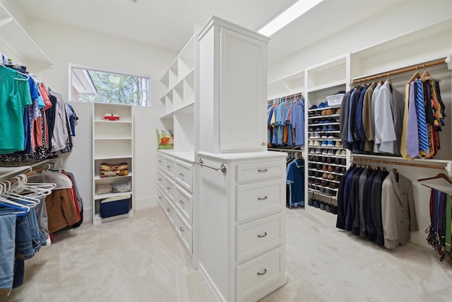 walk in closet featuring light carpet