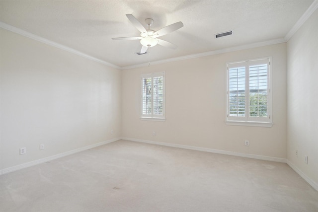 unfurnished room featuring visible vents, plenty of natural light, crown molding, and ceiling fan