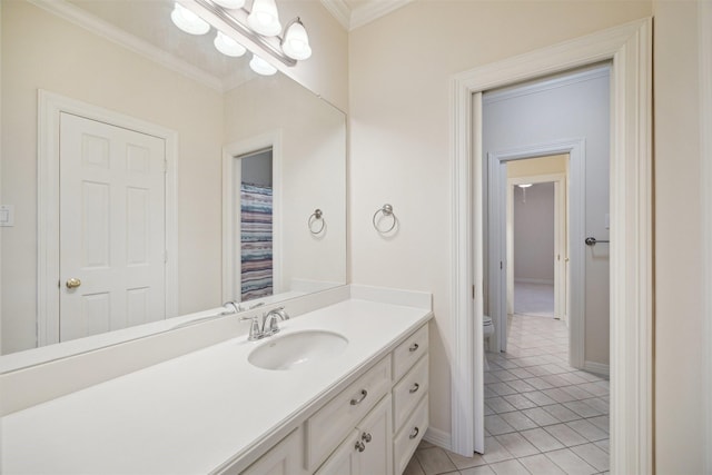 full bath featuring tile patterned flooring, baseboards, toilet, ornamental molding, and vanity