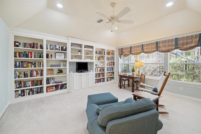 interior space with vaulted ceiling, carpet, visible vents, and ceiling fan