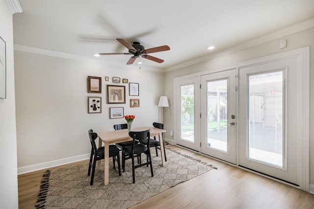 dining space with crown molding, baseboards, light wood-type flooring, recessed lighting, and a ceiling fan