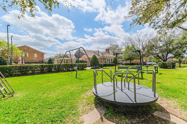 view of yard with playground community and fence