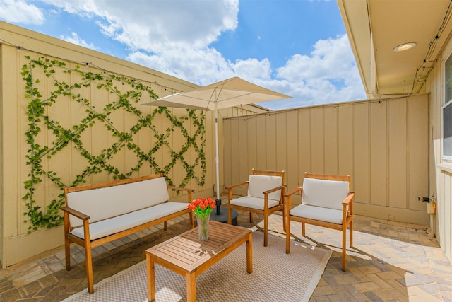 view of patio featuring an outdoor living space and fence