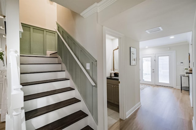 stairs with recessed lighting, crown molding, baseboards, and wood finished floors