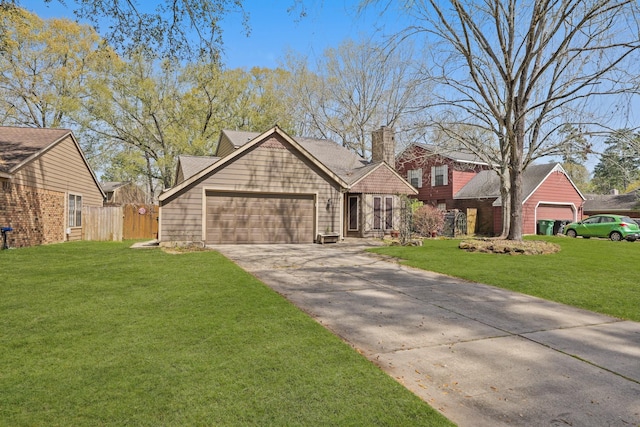 view of front of house featuring a front lawn, fence, a chimney, a garage, and driveway