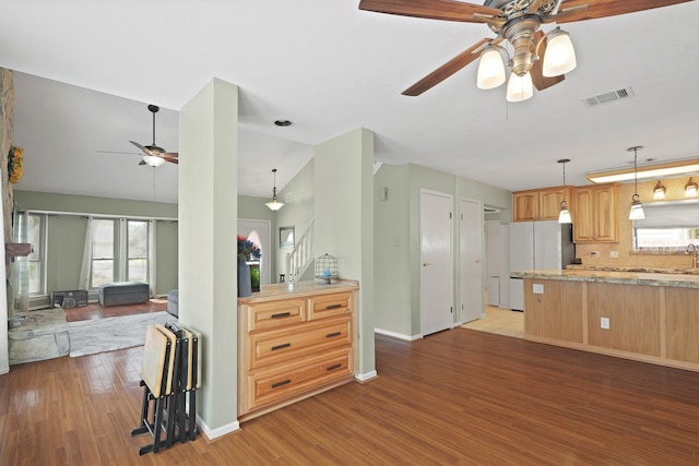 kitchen with visible vents, ceiling fan, pendant lighting, light wood-type flooring, and freestanding refrigerator