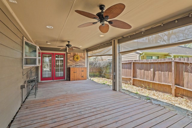 wooden terrace featuring french doors, ceiling fan, and fence