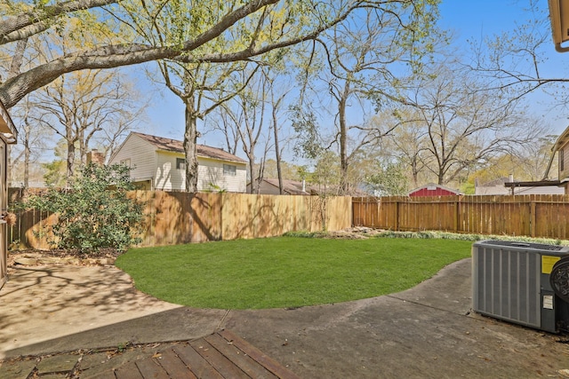 view of yard with a patio, central AC unit, and a fenced backyard