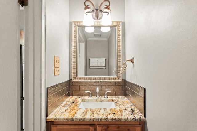 bathroom featuring backsplash, vanity, and crown molding