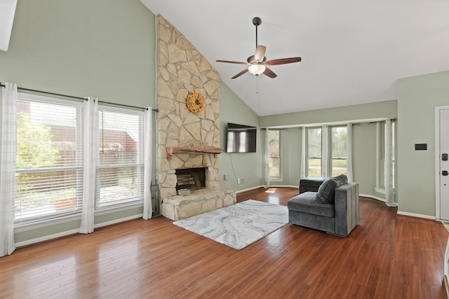 living room with wood finished floors, a ceiling fan, baseboards, high vaulted ceiling, and a fireplace