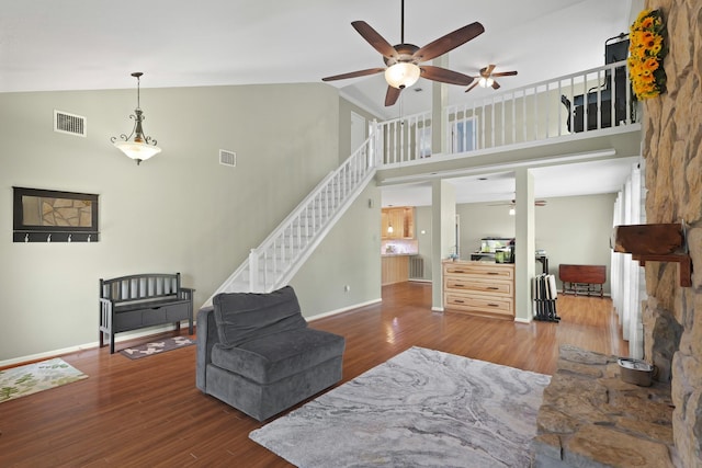 living area with visible vents, ceiling fan, and wood finished floors