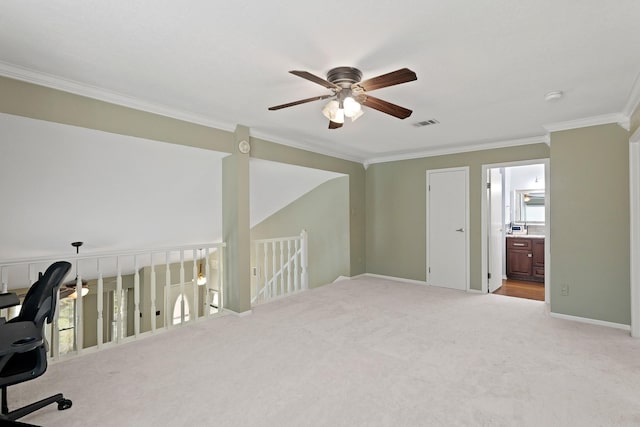 unfurnished office featuring visible vents, a ceiling fan, carpet floors, crown molding, and baseboards