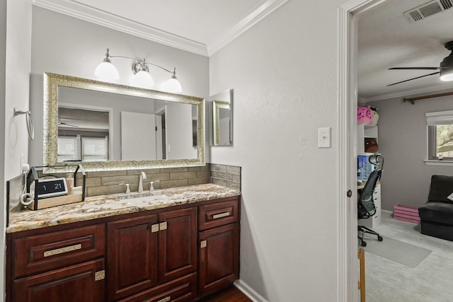 bathroom featuring vanity, a ceiling fan, visible vents, crown molding, and tasteful backsplash