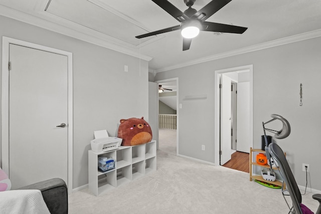 interior space with ornamental molding, carpet flooring, baseboards, attic access, and ceiling fan