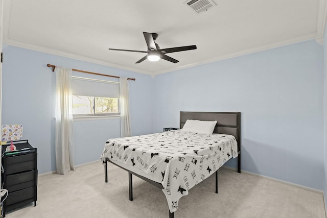 bedroom with baseboards, visible vents, ceiling fan, ornamental molding, and light carpet