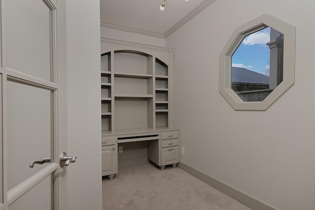 unfurnished office with light colored carpet, baseboards, and ornamental molding