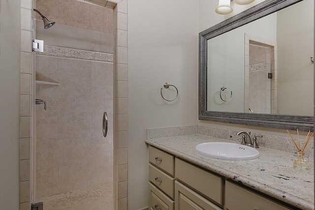 full bath with a stall shower and vanity