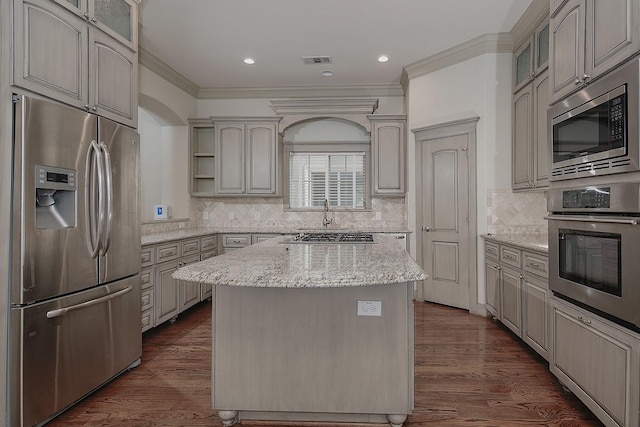 kitchen with visible vents, open shelves, dark wood-style floors, stainless steel appliances, and glass insert cabinets