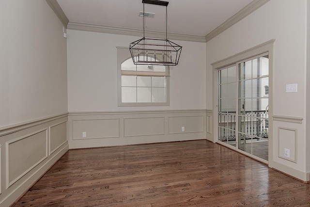 unfurnished dining area featuring visible vents, crown molding, wainscoting, a notable chandelier, and dark wood-style flooring