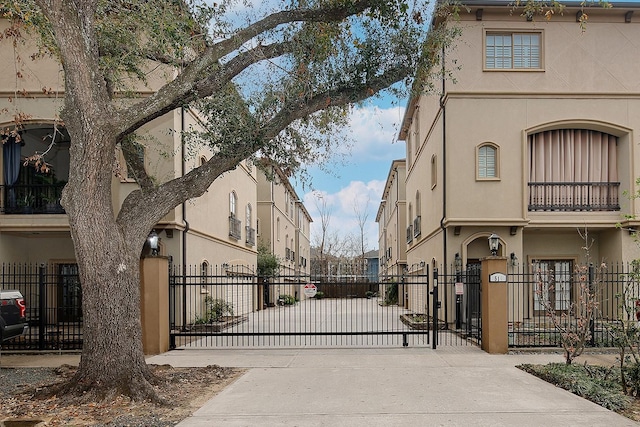 view of road featuring a residential view, a gated entry, and a gate