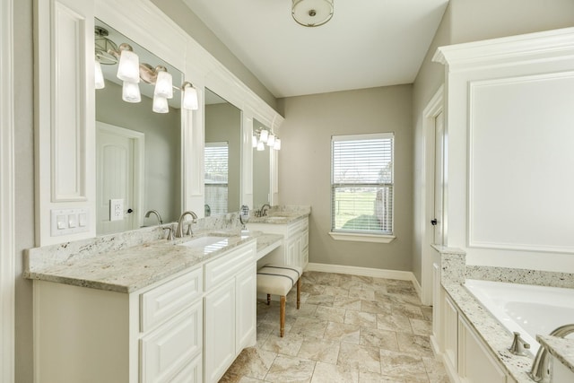 bathroom with vanity and baseboards