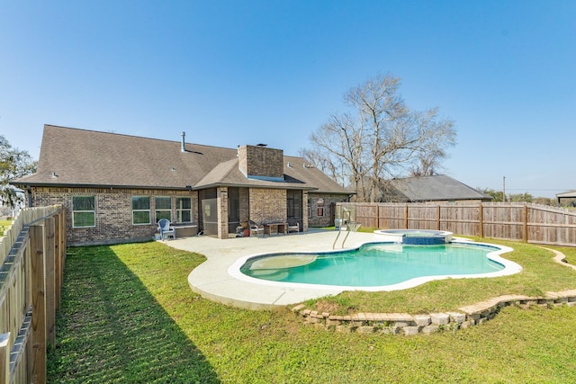 view of swimming pool with a patio area, a yard, and a fenced backyard