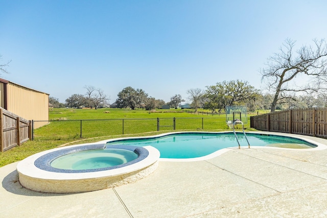 view of swimming pool with a patio area, a lawn, a fenced backyard, and a pool with connected hot tub