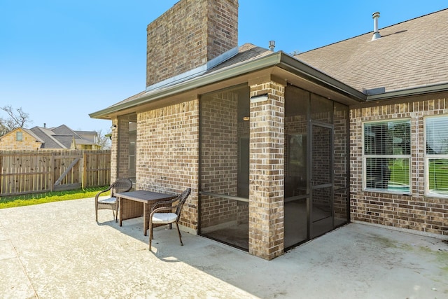 view of patio featuring a gate and fence