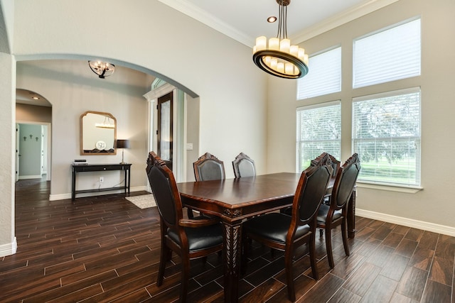 dining space with arched walkways, baseboards, an inviting chandelier, and wood tiled floor