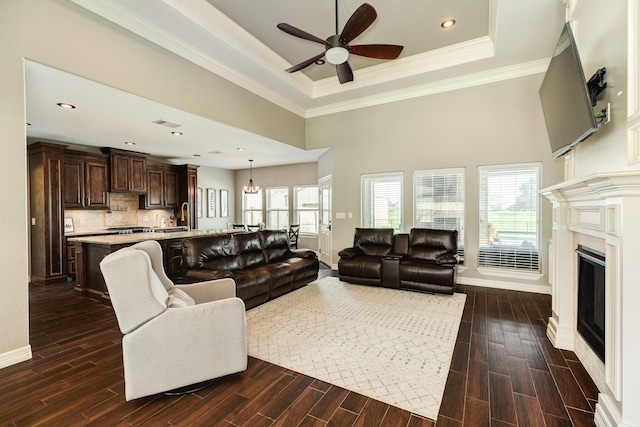 living area featuring wood finish floors, plenty of natural light, and ceiling fan