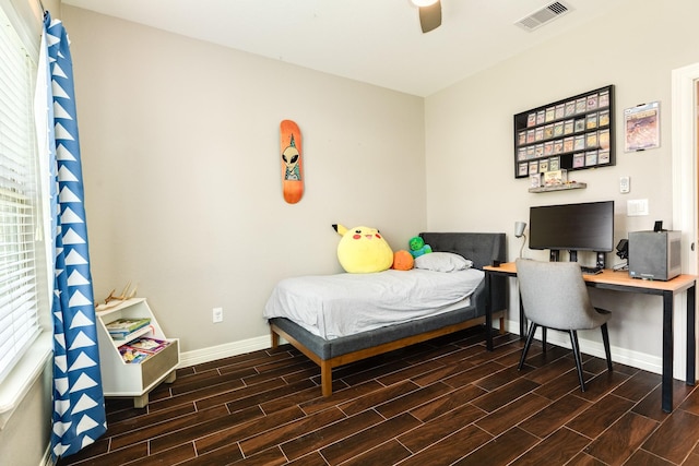 bedroom with ceiling fan, baseboards, visible vents, and wood finish floors