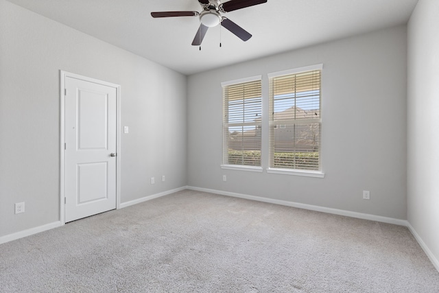 empty room with carpet flooring, baseboards, and ceiling fan