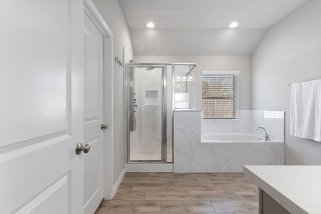 full bathroom featuring recessed lighting, a shower stall, lofted ceiling, a bath, and vanity