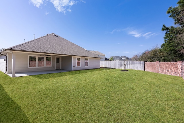 back of property featuring a yard, a patio, ceiling fan, and fence