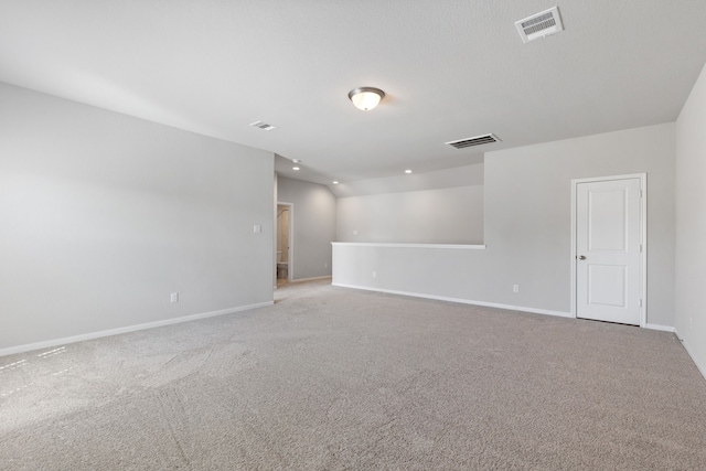 carpeted empty room with visible vents and baseboards