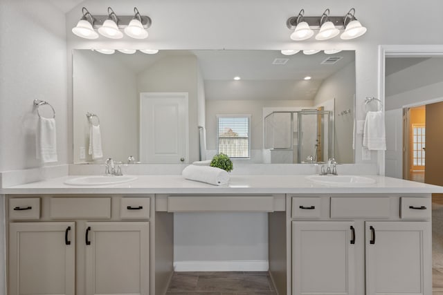 bathroom with a sink, visible vents, a stall shower, and double vanity