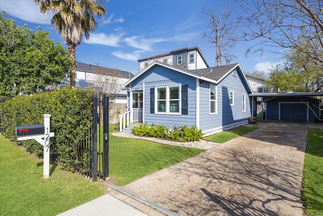 bungalow-style house featuring a garage, an outbuilding, concrete driveway, and a front yard