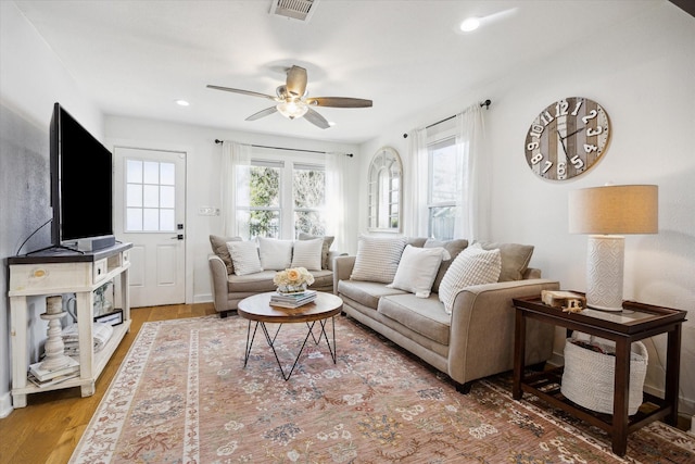 living area featuring recessed lighting, wood finished floors, visible vents, and ceiling fan