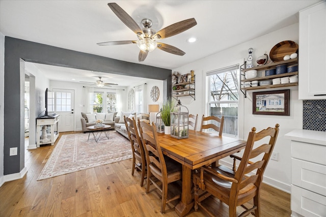 dining room featuring recessed lighting, a ceiling fan, baseboards, and light wood finished floors