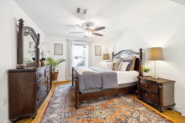 bedroom featuring a ceiling fan, visible vents, and light wood-type flooring