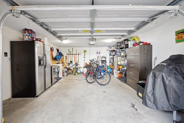 garage with stainless steel fridge with ice dispenser