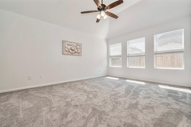 empty room featuring carpet flooring, a ceiling fan, baseboards, and high vaulted ceiling