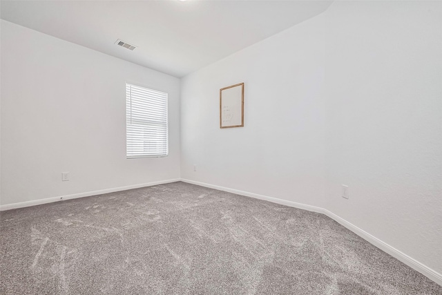 unfurnished room with visible vents, baseboards, and carpet flooring