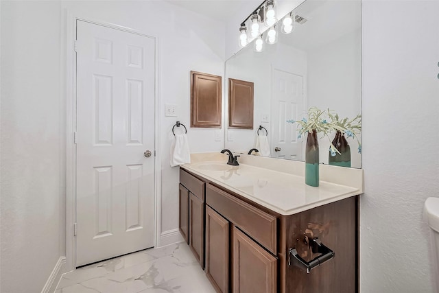 bathroom with visible vents, toilet, marble finish floor, baseboards, and vanity