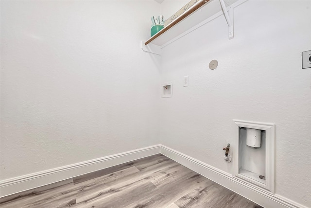 laundry area with wood finished floors, hookup for a gas dryer, baseboards, hookup for a washing machine, and laundry area